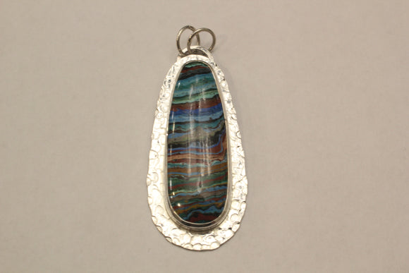 Rainbow Calsilica bezel set in textured sterling silver pendant